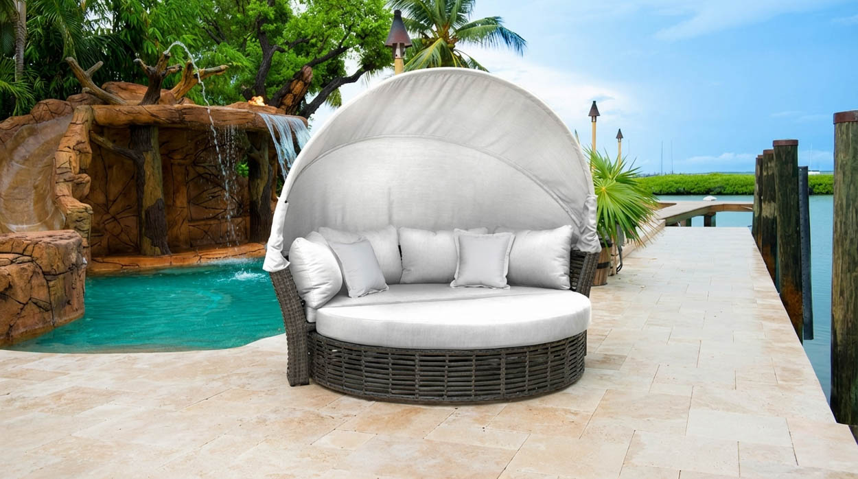 Luxury outdoor lounge pod installed beside waterfront pool in North Florida, showcasing custom-built relaxation furniture.