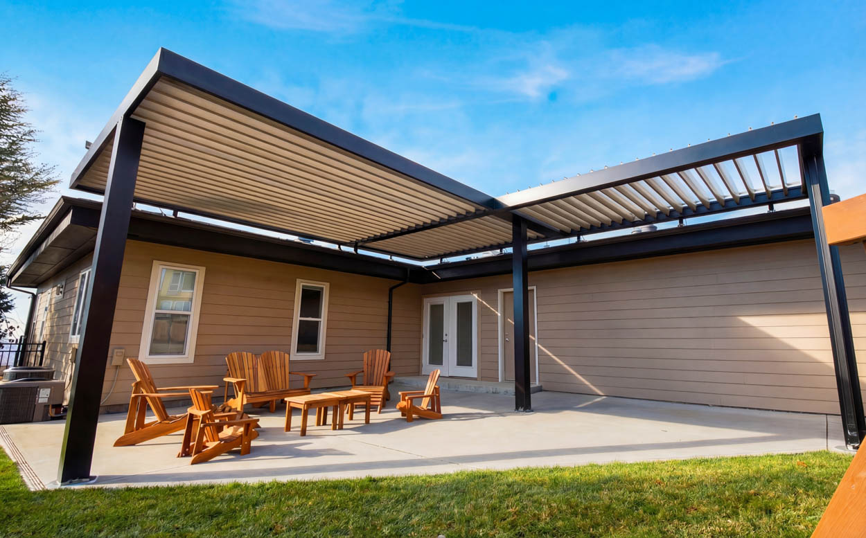 Large motorized louvered roof covering patio seating area, offering flexible shade and rain protection for Florida homes.