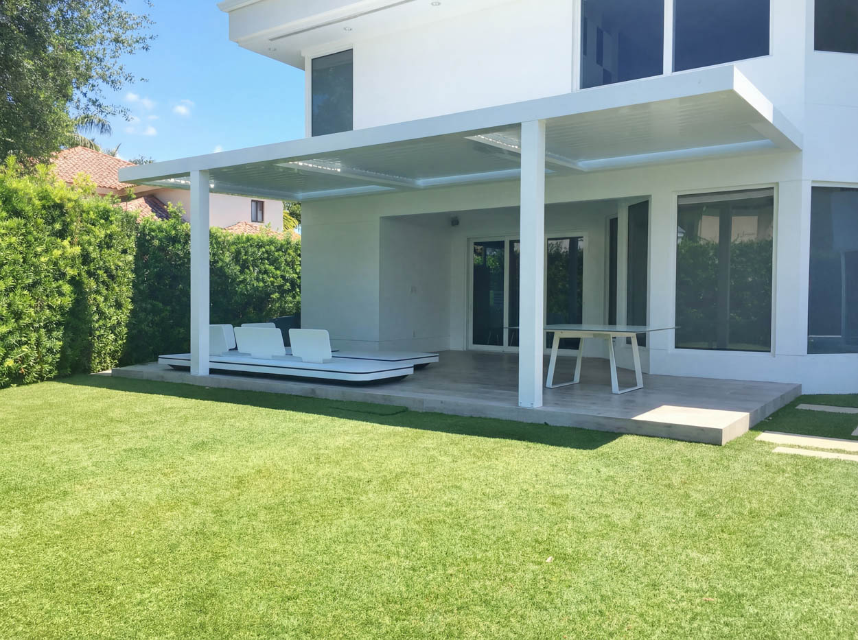 Modern aluminum louvered roof attached to luxury home, offering shade, ventilation, and sleek outdoor coverage.