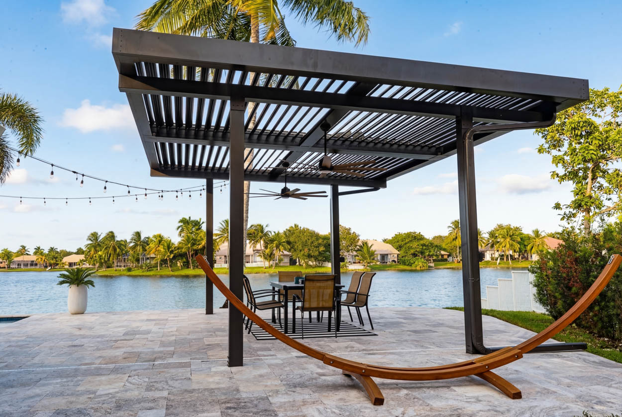 Motorized louvered roof installed on modern property, providing adjustable sunlight control and contemporary outdoor design.