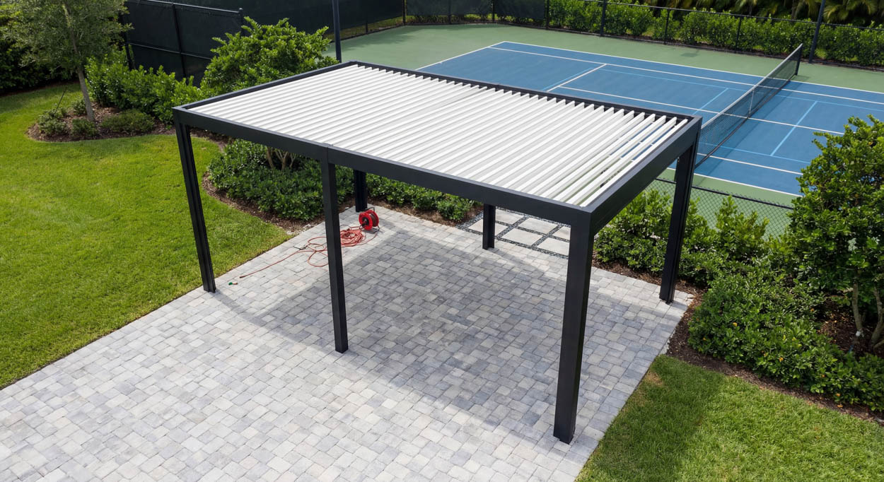 Motorized pergola with adjustable louvers over pool deck, enhancing outdoor living and sun management in Florida.