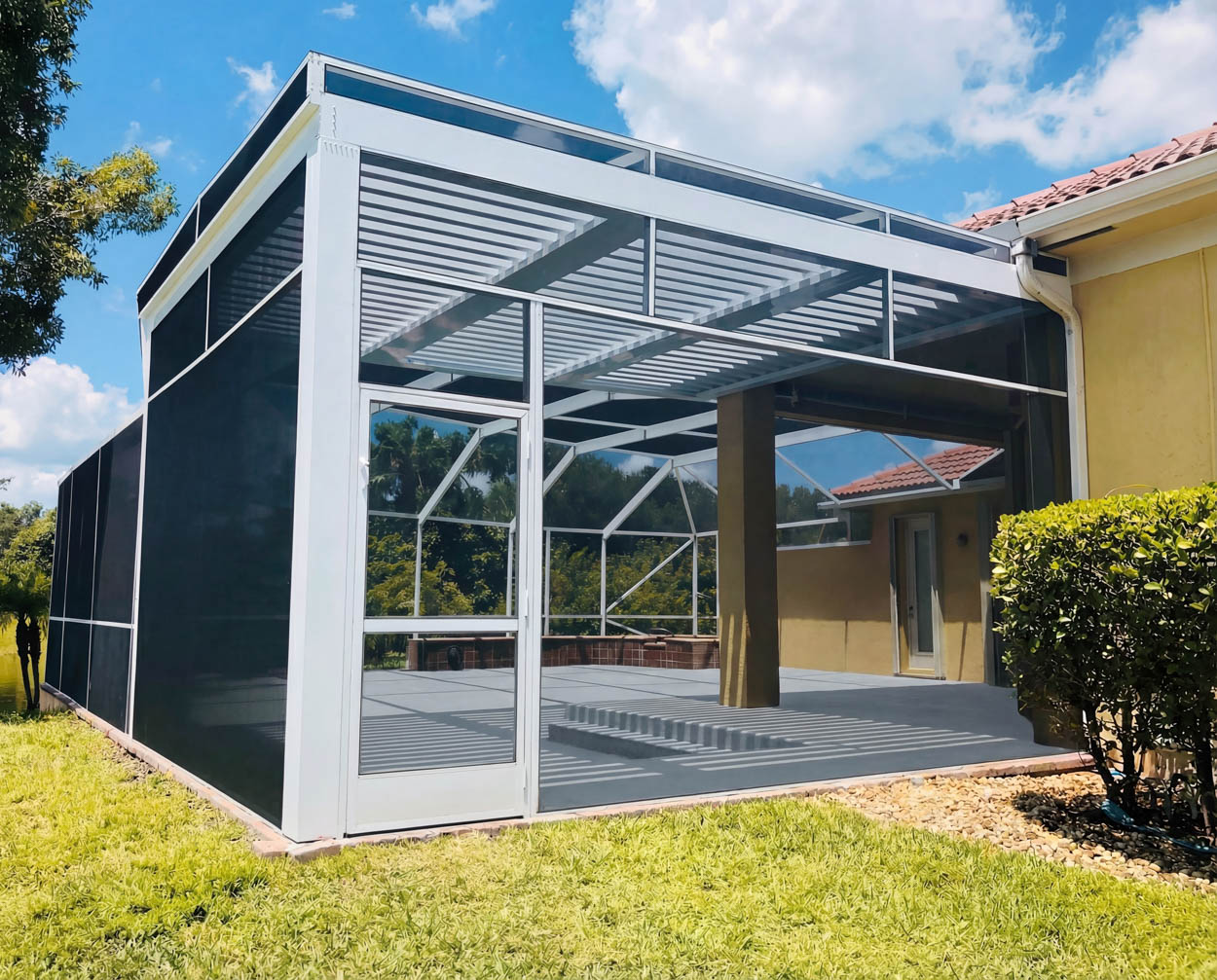 Custom-built patio screen enclosure with pergola-style roof structure, providing shade and outdoor comfort for North and South Florida homeowners.