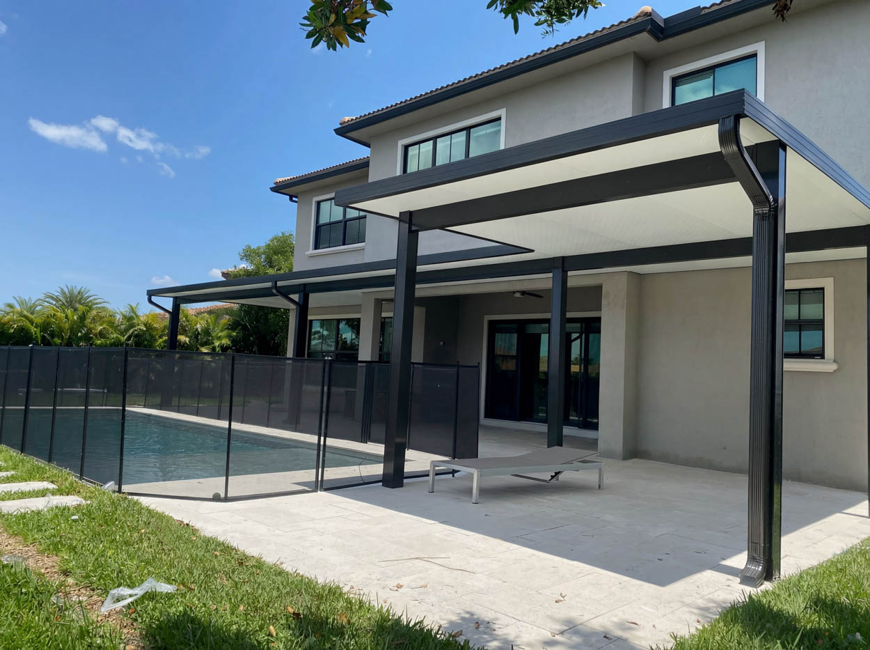 Backyard pergola and patio cover installation in Florida home, designed by professional outdoor living builders.