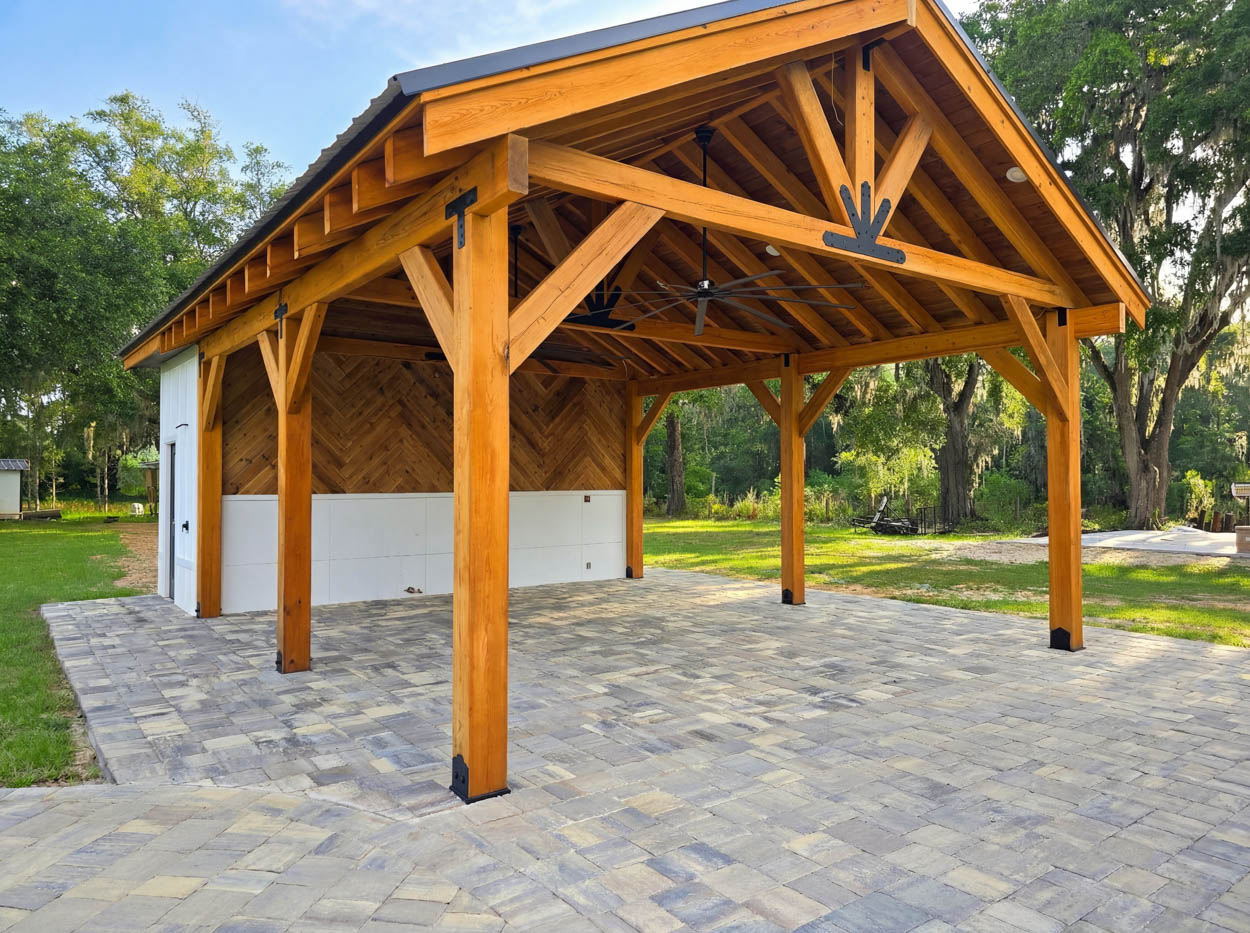 Custom wood pavilion construction by Florida pergola contractors, showcasing exposed beams and premium craftsmanship.