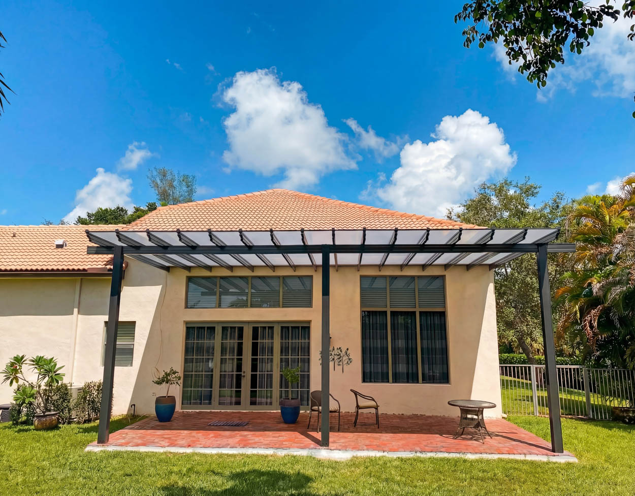 Custom pergola installation over backyard deck by Florida contractors, blending landscape design and outdoor structure.