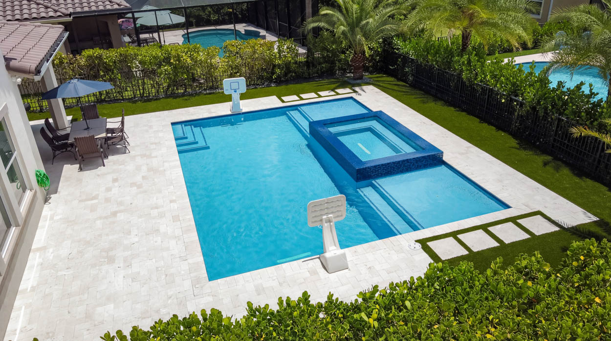 Custom pool and spa construction with integrated pergola by experienced builders in North & South Florida, designed for upscale outdoor living.