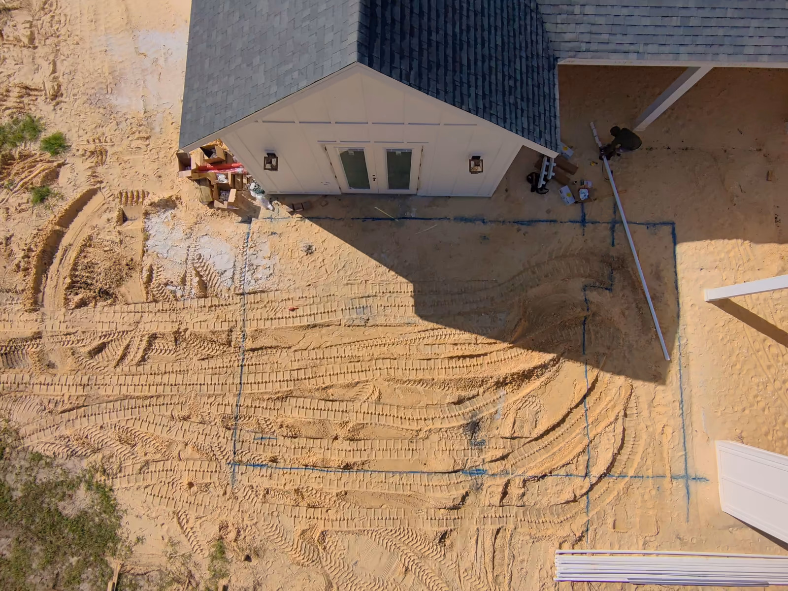 Top-down drone view of the approved pool and spa layout painted on the sand next to the house, new pool build in Florida