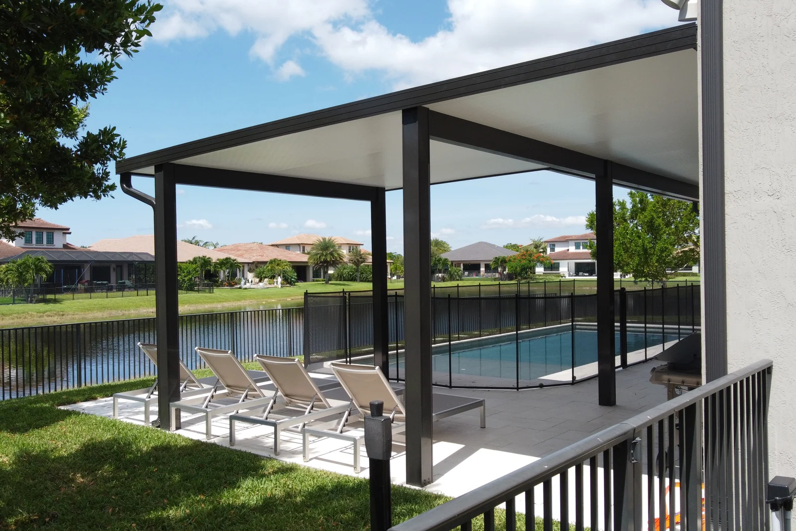 Aerial view of a backyard lap pool with an aluminium patio cover