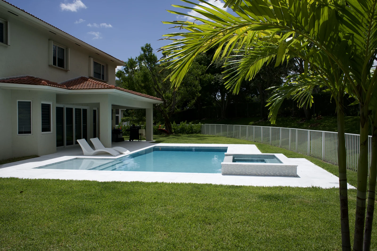Completed backyard pool with raised spa and covered lanai