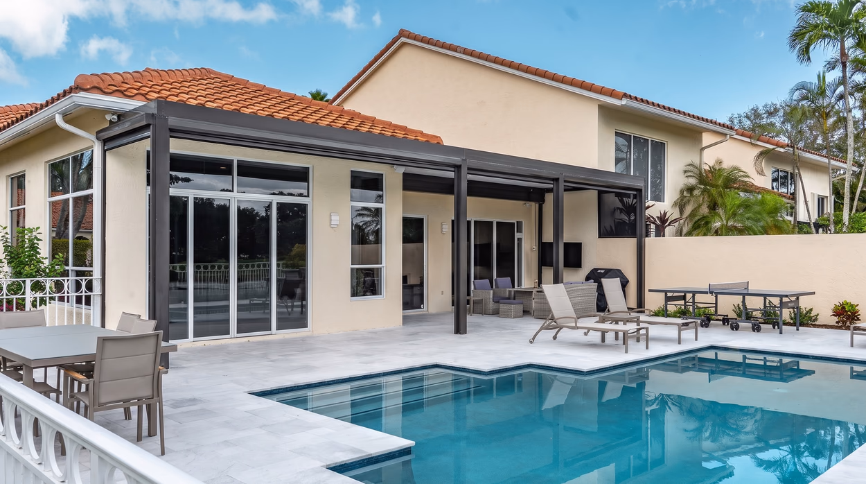 The patio cover from the deck, shading the sliding glass doors, the lounge chairs and the dining area.